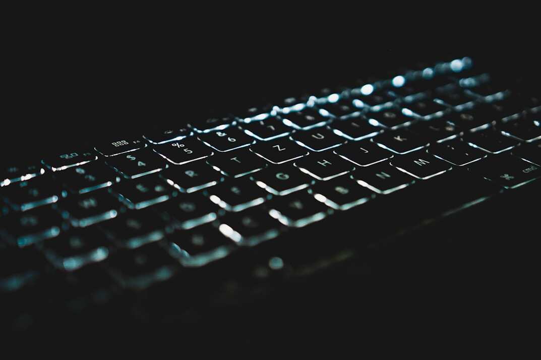 Writer typing an article on a laptop